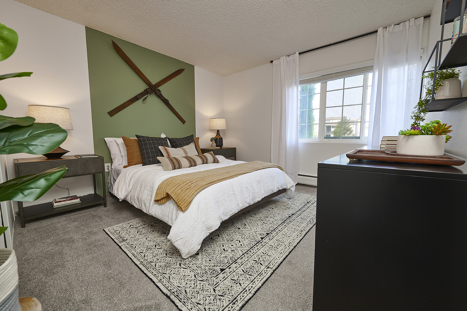 bedroom with grey carpet, queen bed and large window