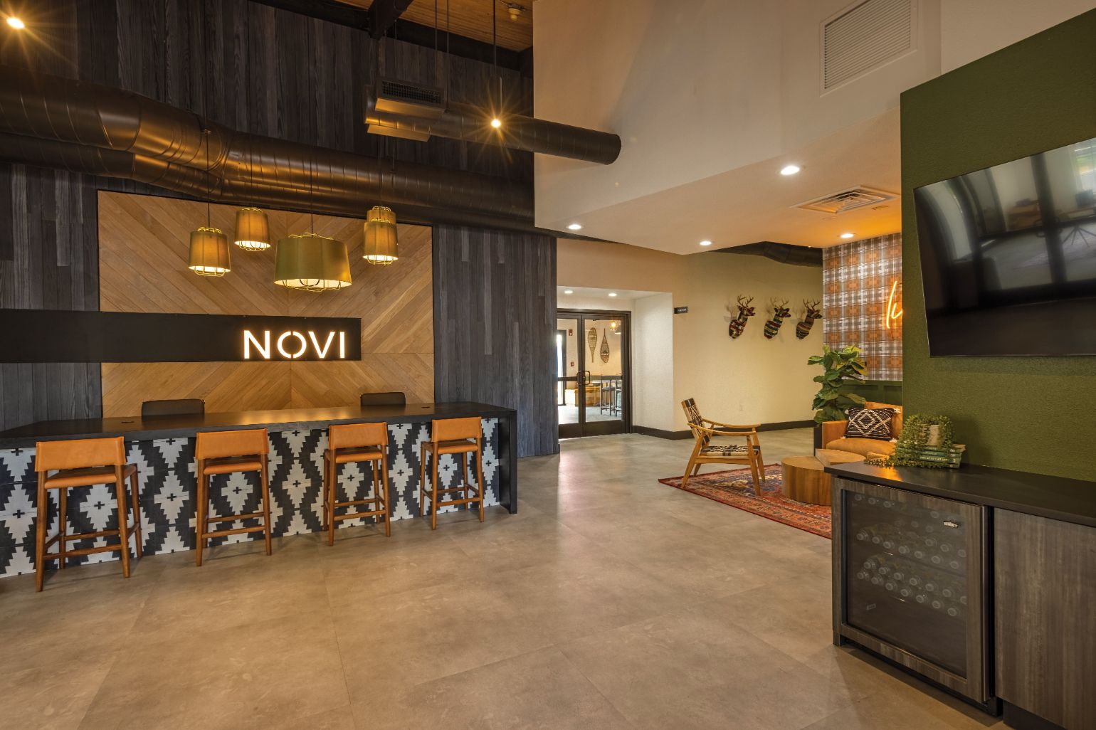 spacious clubhouse view of floor, servicing island, and sitting area