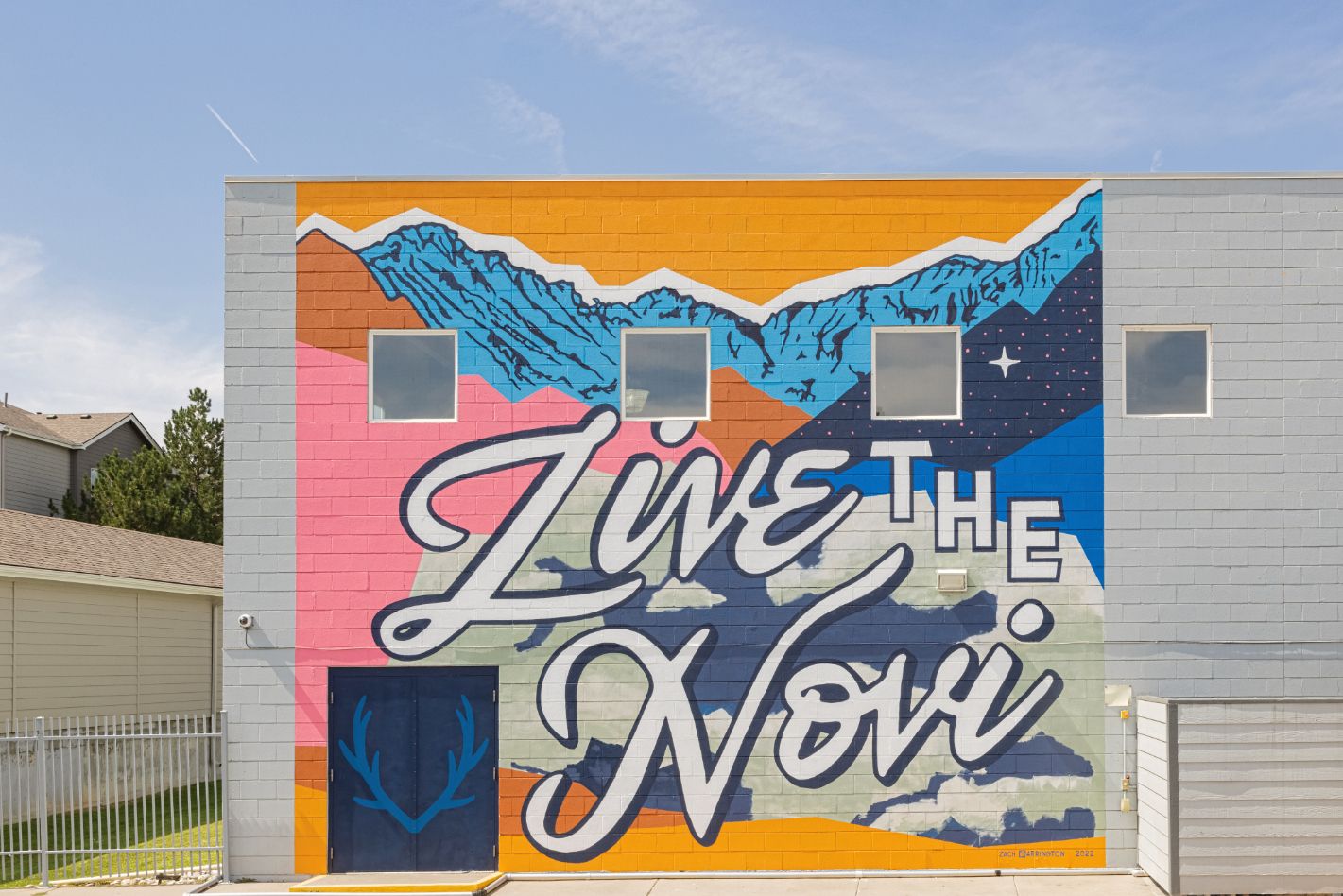 colorful Mural near the pool that says LIVE the Novi