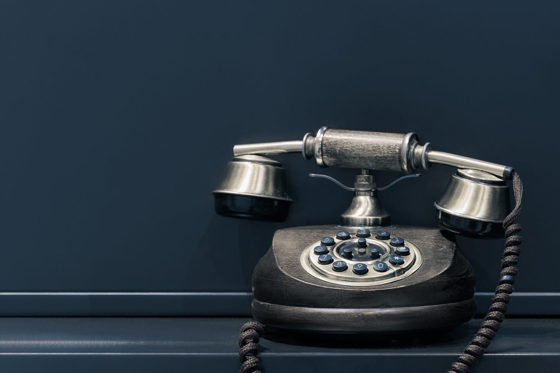 old school telephone with a circular dial